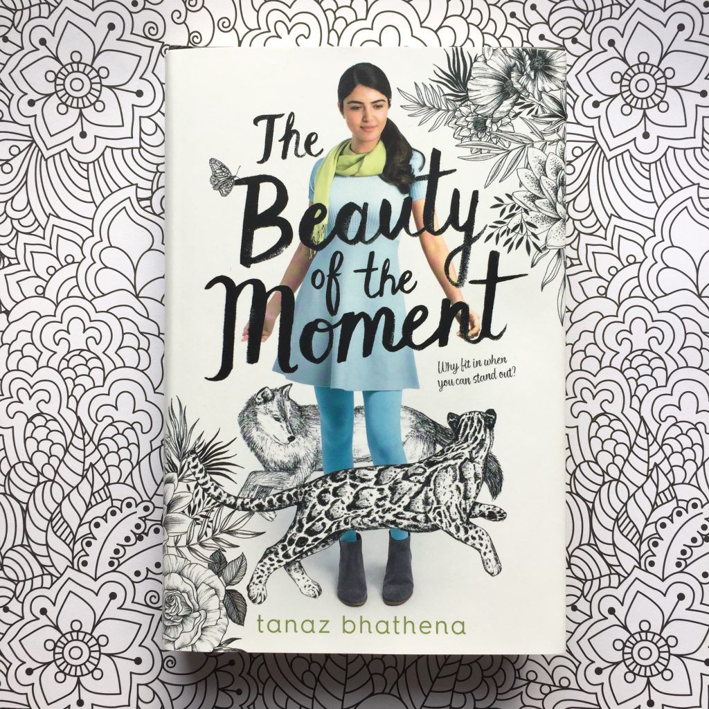 Book 'The Beauty of the Moment' on a sheet of colouring paper