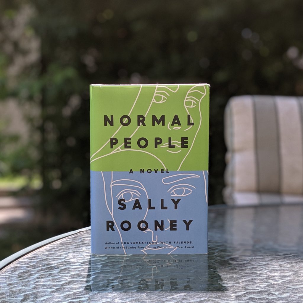 Normal People by Sally Rooney on an outdoor patio table